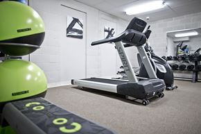 Sioux City apartment for rent - A gym with a treadmill, exercise bike and weights.