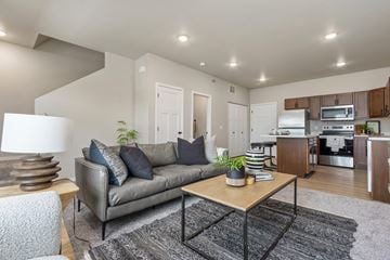Sioux Falls townhouse for rent - A modern living room with a grey sofa and a wooden coffee table.