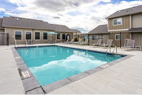 Waukee townhouse for rent - Sparkling blue pool surrounded by lounge chairs.