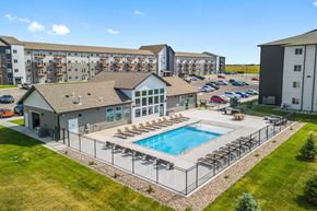 Box Elder apartment for rent - A large building with a pool in front.