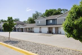 Mitchell townhouse for rent - A row of houses with a gravel driveway in front.