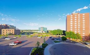 Sioux Falls apartment for rent - a view of a parking lot in a city with tall buildings
