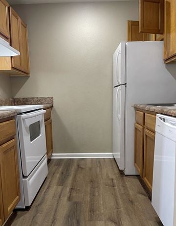 Searcy apartment for rent - A kitchen with a white refrigerator and a white dishwasher.