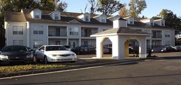 Jonesboro apartment for rent - a car is parked in a parking lot in front of an apartment building