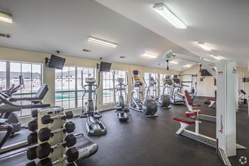 Jonesboro apartment for rent - a gym with cardio machines and weights and a view of a pool