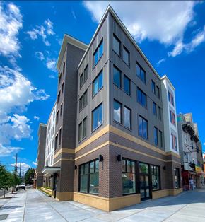 Jersey City apartment for rent - a tall building with a blue sky in the background