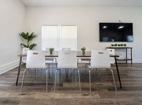 Hillsborough Township apartment for rent - a dining room with a table and chairs and a tv on the wall