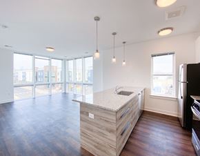 Somerset apartment for rent - an empty living room with a kitchen and a large window