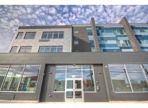 Keansburg apartment for rent - a building with many windows and a cloudy sky