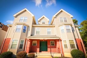 Keansburg apartment for rent - a large red brick house with a green door