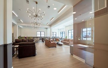 Maple Shade apartment for rent - A modern living room with brown furniture and a chandelier.