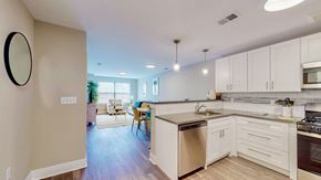 Maple Shade apartment for rent - A kitchen with white cabinets and a wooden island.