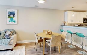 Maple Shade apartment for rent - A dining room with a table set for two and a couch with a throw on it.