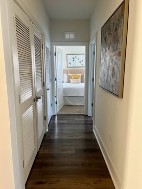 Hillsborough Township apartment for rent - a narrow hallway with a bedroom in the background and a door to a room with