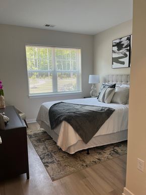 South Brunswick apartment for rent - A bedroom with a bed, nightstand, and window.