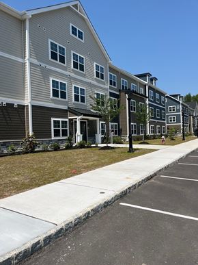 South Brunswick apartment for rent - Apartment building with a parking lot in front.