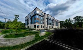 Princeton apartment for rent - A modern building with a parking lot in front.