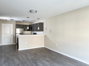 Newark apartment for rent - an empty living room and kitchen with a white wall and wood floor