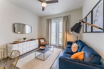 Grand Prairie apartment for rent - A living room with a blue couch and a gold chair.