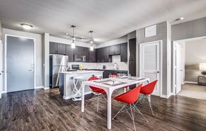 San Antonio apartment for rent - a dining area with a table and chairs and a kitchen in the background at Republic at Alamo Heights, Texas, 78209