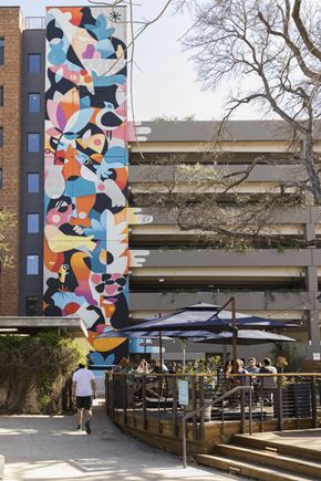San Antonio apartment for rent - Outdoor courtyard with colorful mural and dining area at THE'68 Apartments, Texas