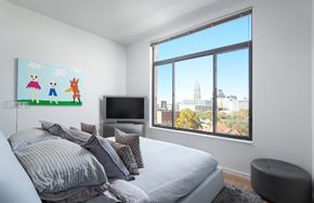 San Antonio apartment for rent - Bedroom with large window and city skyline views at THE'68 Apartments, San Antonio, TX