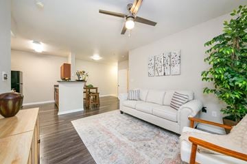 Universal City apartment for rent - A living room with a white couch and a ceiling fan.