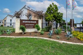 Austin apartment for rent - the entrance to northeast apartments sign in front of a fence at Northchase, Texas, 78753