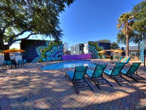 Austin apartment for rent - Pool area with lounge chairs and artistic wall at Azure Apartments, Austin, 78752