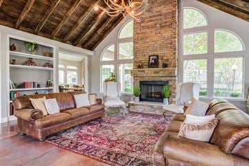 Katy apartment for rent - A living room with a brown leather couch and a fireplace.