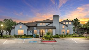 Conroe apartment for rent - A large, modern house with a spacious driveway in front at Rosemary Apartments, Conroe