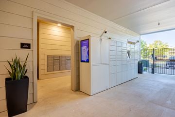 Boerne apartment for rent - A modern house entrance with a digital screen and a plant.