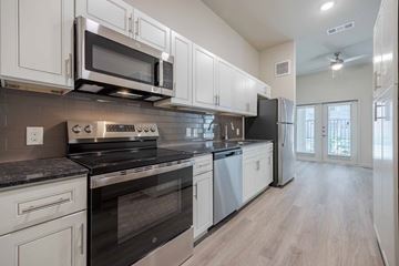 Boerne apartment for rent - A modern kitchen with white cabinets and stainless steel appliances.
