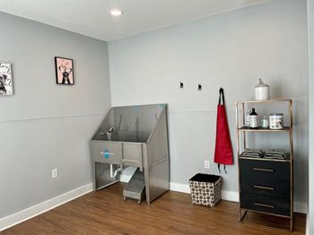 A small room with a desk and a dresser