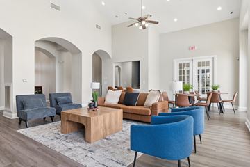 San Antonio apartment for rent - A living room with a blue chair and a brown couch.