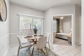 San Antonio apartment for rent - A dining room with a table set for two and a bedroom in the background.