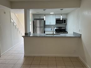 Austin apartment for rent - Kitchen with stainless steel appliances and granite breakfast bar at Azure Apartments, Texas, 78752