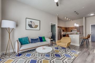 San Antonio apartment for rent - A living room with a white sofa and a yellow chair.