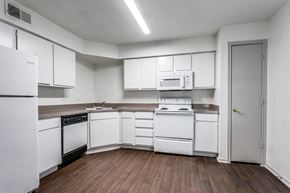 San Antonio apartment for rent - a kitchen with white cabinets and white appliances  at Rosillo Creek Apartments, San Antonio, TX