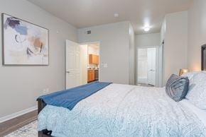 Universal City apartment for rent - A bedroom with a large bed and a painting on the wall.