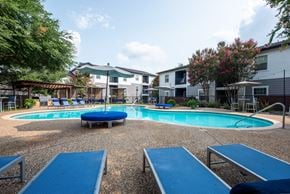 Universal City apartment for rent - A round blue pool surrounded by a gravel area and a few chairs.