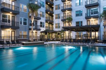The swimming pool in front of the apartment building at night