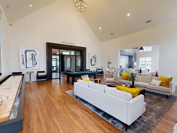 A living room with a couch and a pool table