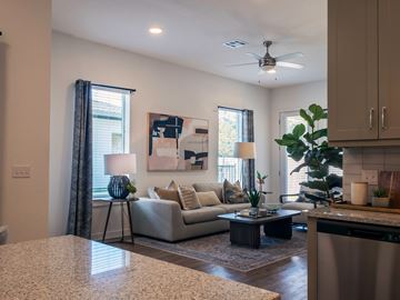 Leander apartment for rent - A living room with a couch, a table, and a painting on the wall.