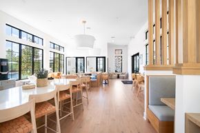 Austin apartment for rent - Bright communal dining space with wood furnishings at Hangar at Bergstrom Apartments, Austin, 78744