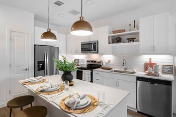 Bright kitchen island with three place settings