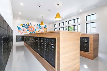 Mail room with wooden counters and black mailboxes
