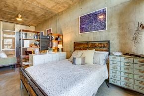 San Antonio apartment for rent - Industrial loft bedroom with exposed concrete walls at 1221 Broadway Lofts Apartments, Texas
