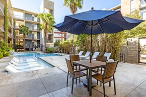 San Antonio apartment for rent - Pool deck with dining area and umbrella at 1221 Broadway Lofts Apartments, San Antonio, 78215