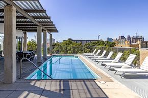 San Antonio apartment for rent - Rooftop pool with lounge chairs and pergola at 1221 Broadway Lofts Apartments, San Antonio, TX 78215